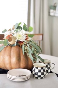 Floral arrangement inside of a pumpkin.