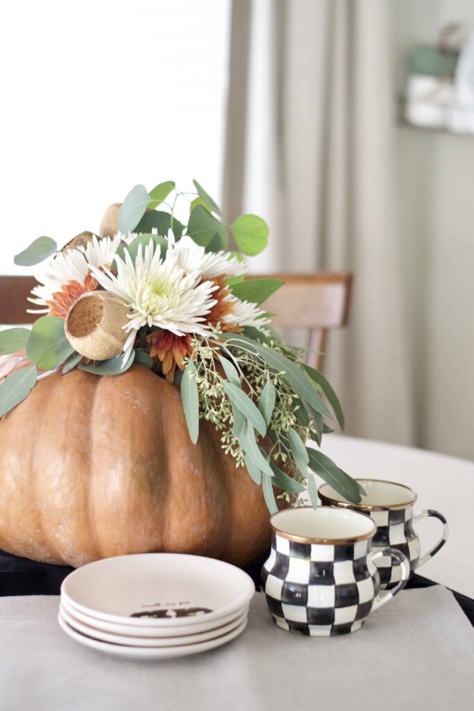 Floral arrangement inside of a pumpkin.
