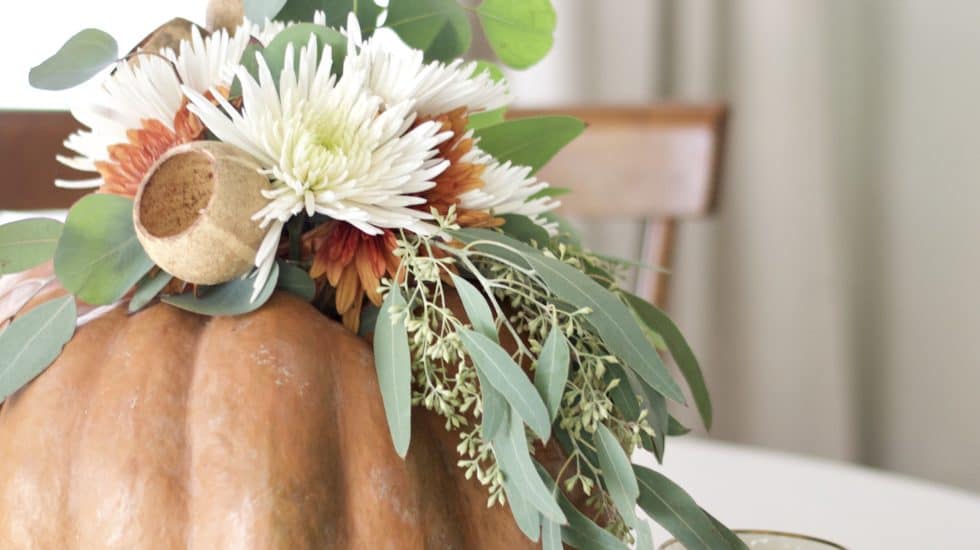 Floral arrangement inside of a pumpkin.
