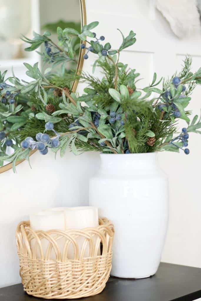 Christmas entry way floral arrangement with berries and cedar