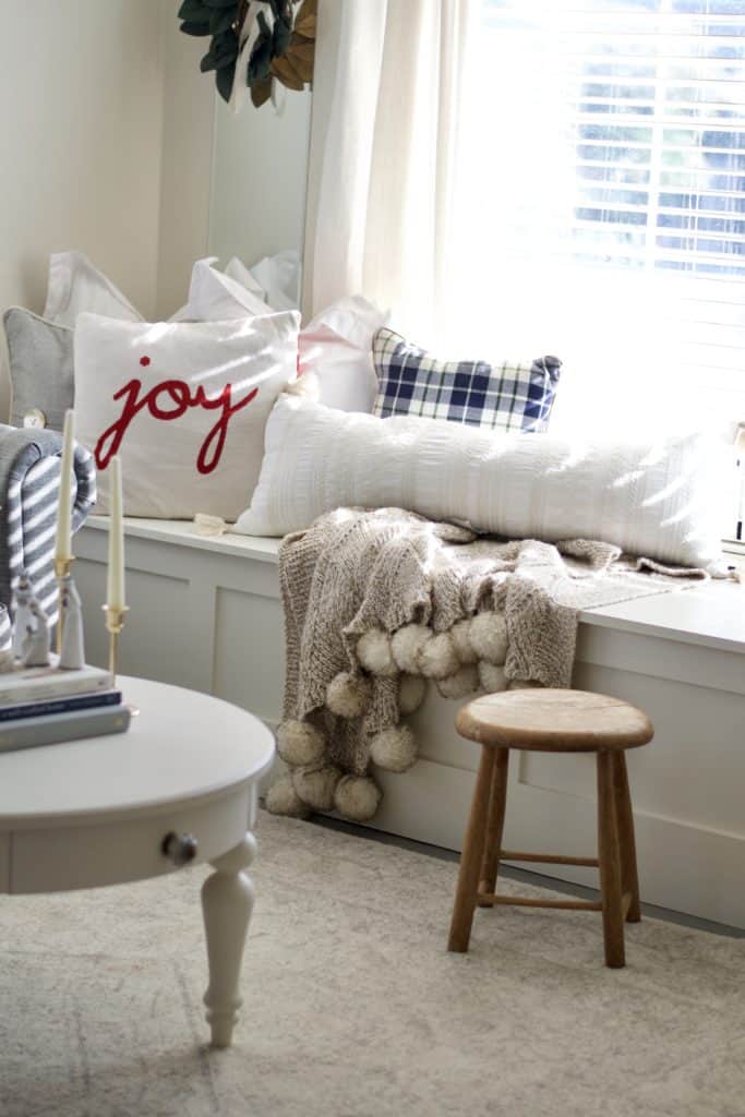 Window bench with christmas pillows.